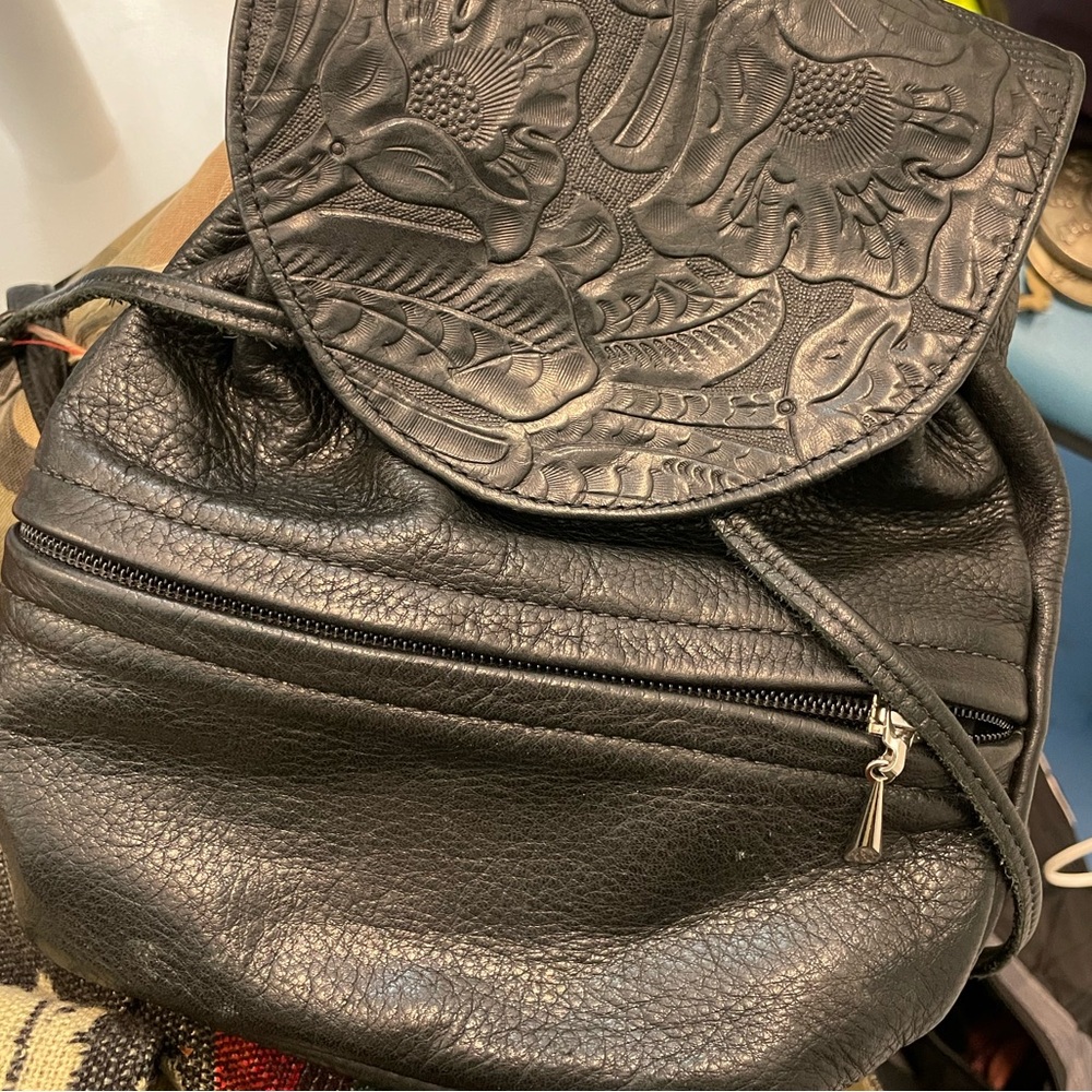 small black floral embossed leather backpack with clip-on straps